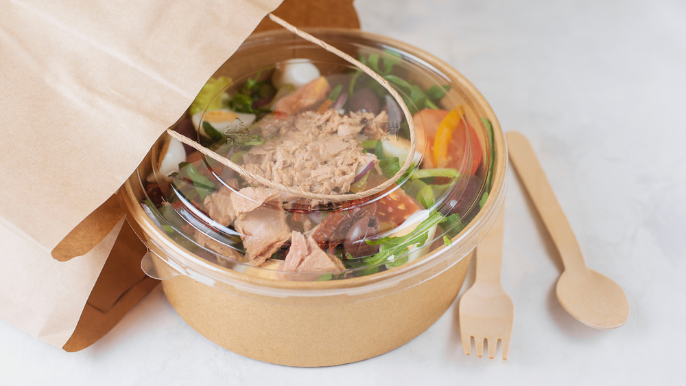 Takeout bag with container of salad