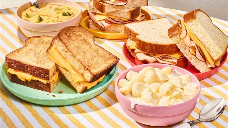 Panera sandwich spread with mac and cheese on a striped table