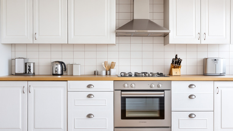 White kitchen with stainless steel appliances