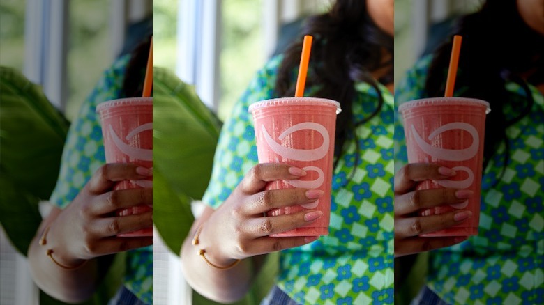 woman holding Jamba watermelon smoothie with orange straw