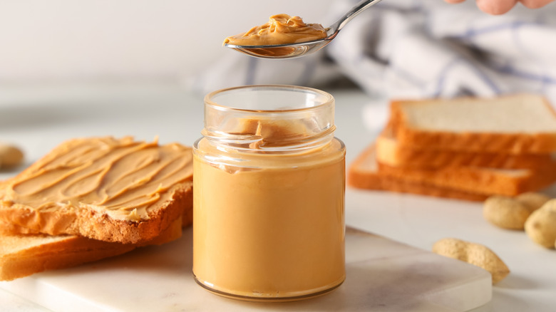 Spoon scooping peanut butter