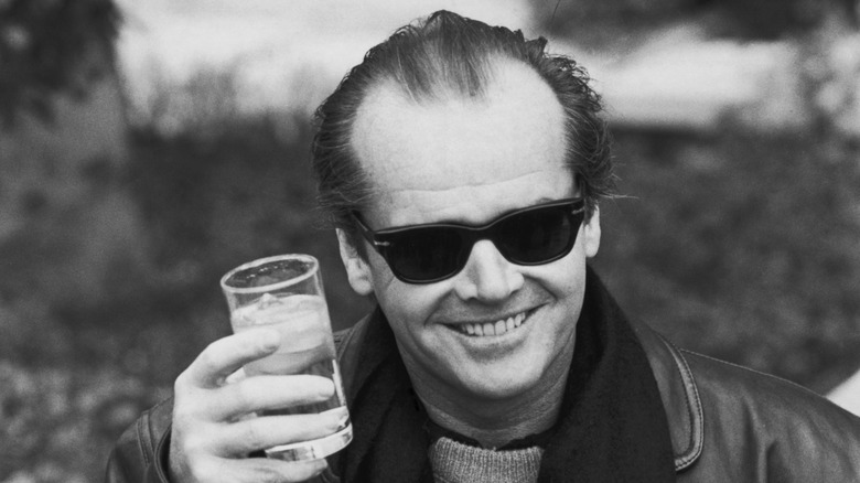 1980s actor Jack Nicholson wearing sunglasses and holding a glass