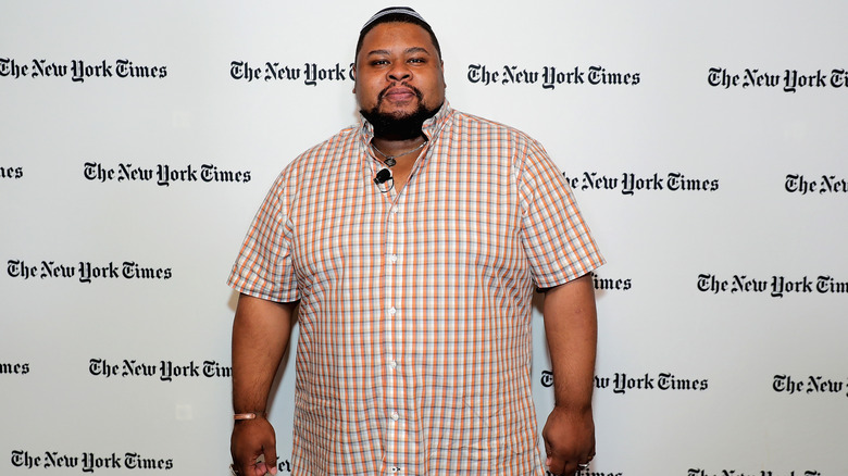 Michael Twitty infront of the New York Times banner