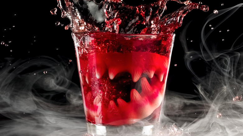 Red cocktail with vampire teeth