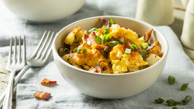Breakfast bowl of scrambled eggs, bacon, and potatoes