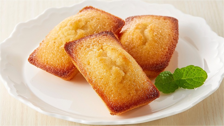 Three small financiers on a porcelain white plate 