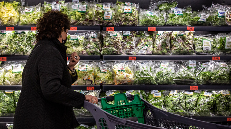 woman browsing bagged salad