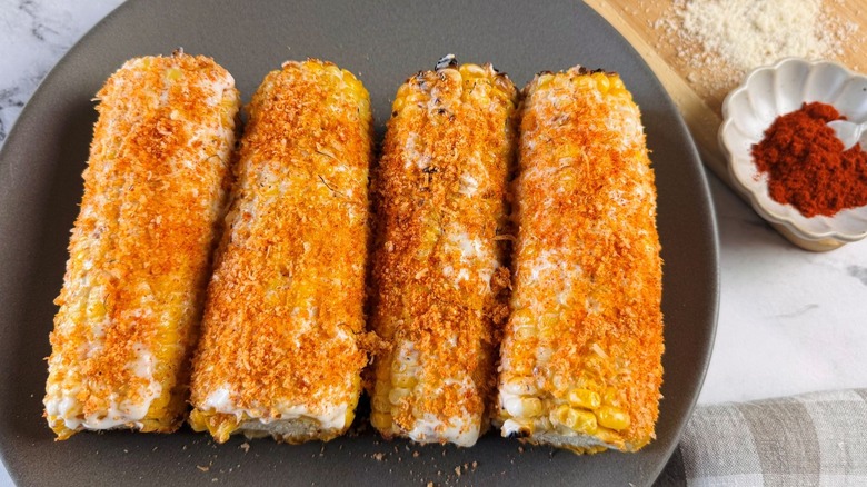 Seasoned corn on the cob on plate