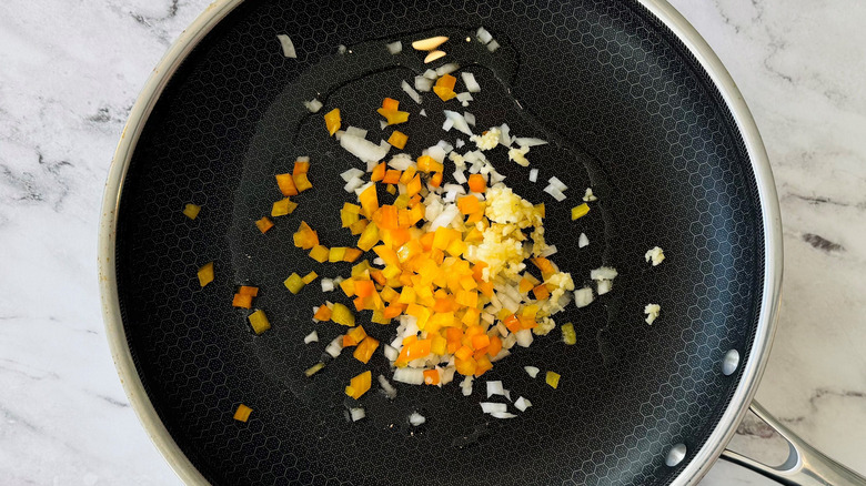 Diced onion, pepper, and garlic in pan