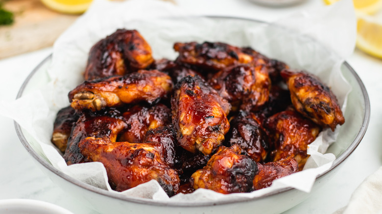 saucy chicken wings in bowl
