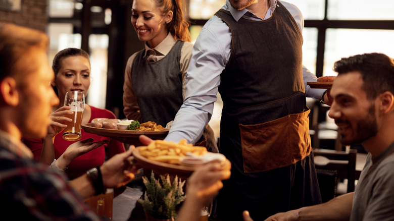 Waiter bringing food to table