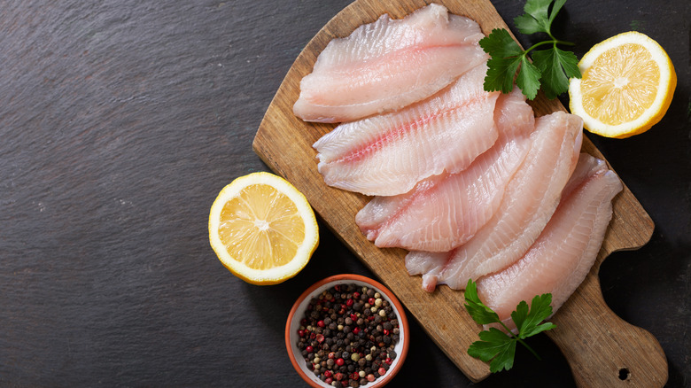fresh tilapia filets on board