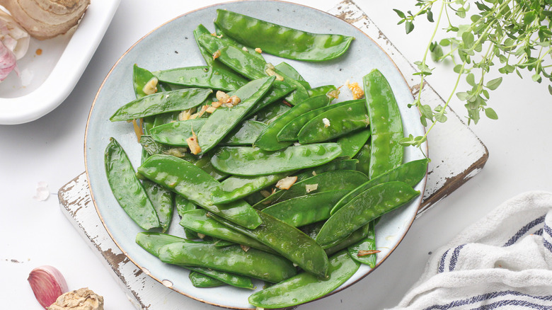 cooked snow peas on a plate