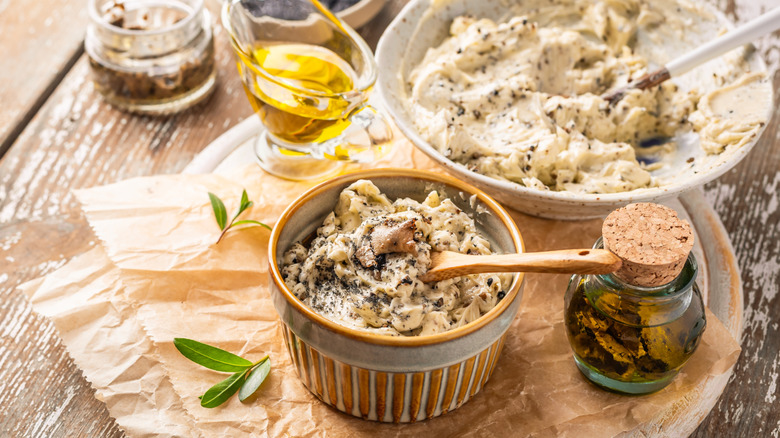 Truffle butter and ingredients on wooden table.