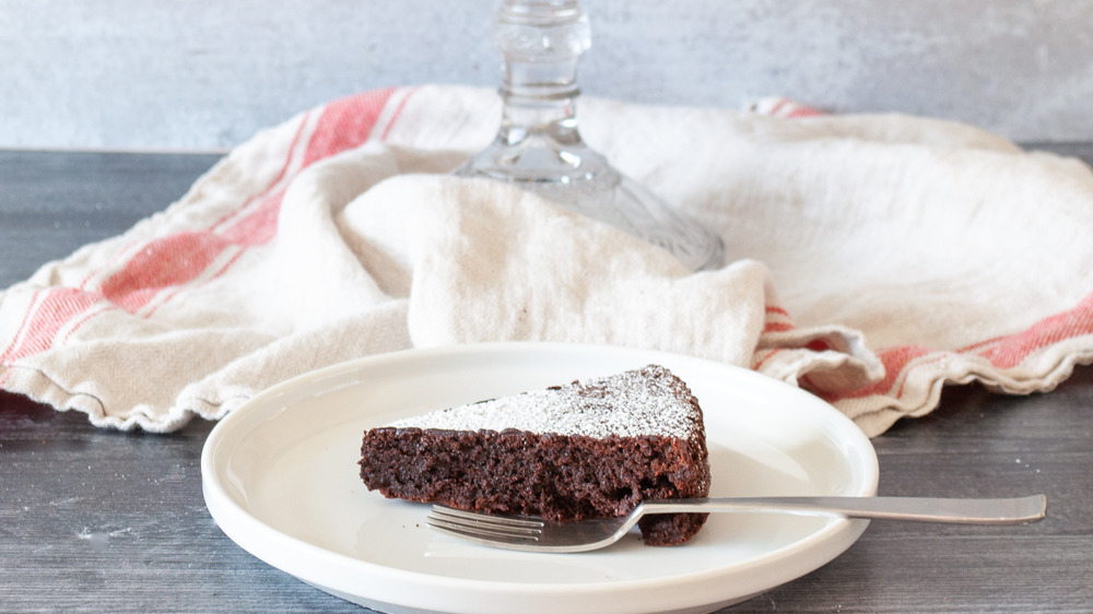 slice of flourless chocolate cake on plate with fork