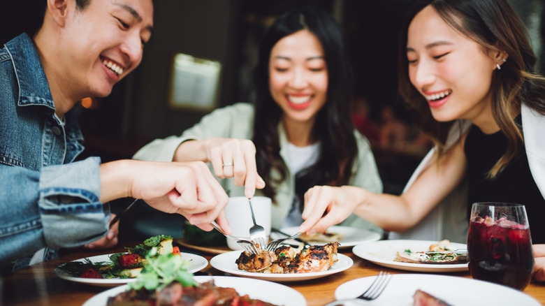 A group of young people enjoying a meal together