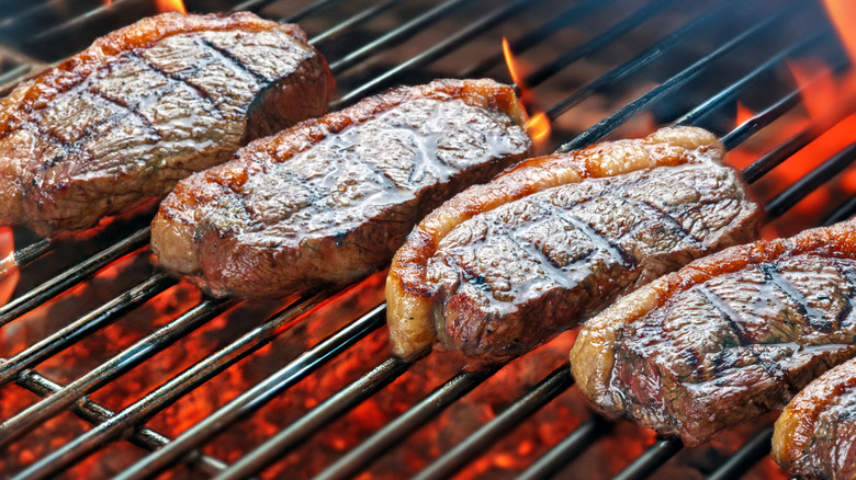 Sliced picanha cooking on a grill