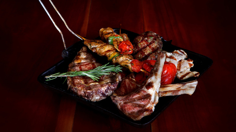 A mix of different types of meat on a pan