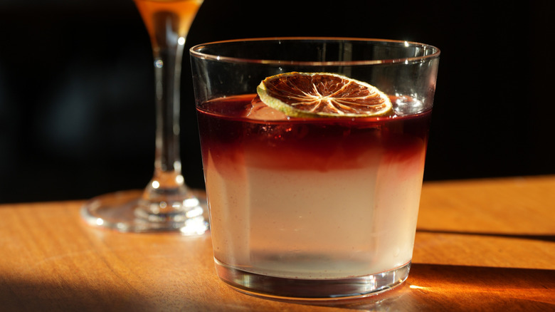 two cocktails sitting on bar