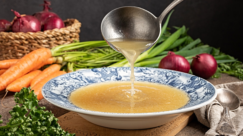 Chicken stock in a bowl with vegetables