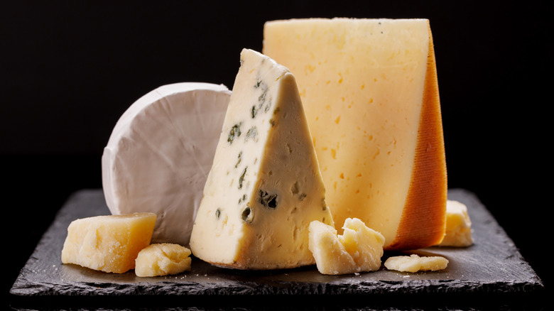 Variety of cheese on a black board