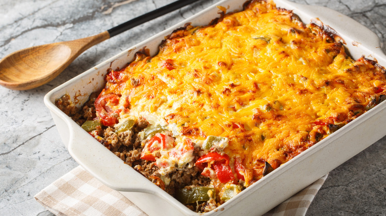 John Wayne casserole with beef, cheese, and chiles in white serving dish.