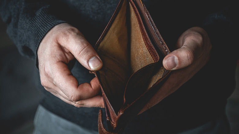 Man holding empty wallet