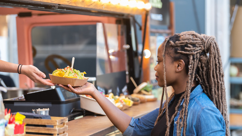 woman getting food truck order