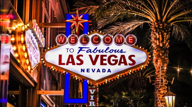 Welcome to Fabulous Las Vegas Nevada sign and sky scrapers with palm trees