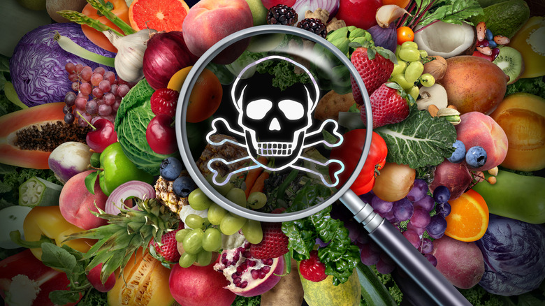 Produce items covered by a magnifying glass with a skull and crossbones