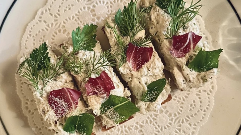 Elegant crab toasts on plate with doily