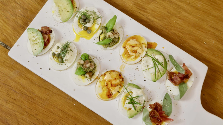 Deviled egg flight on white cutting board