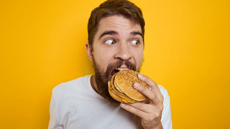 man eating burger