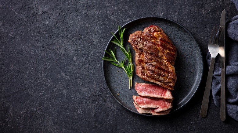 rare steak garnished with rosemary