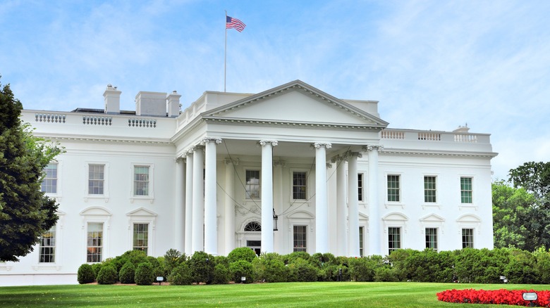 White House with flag flying and lawn