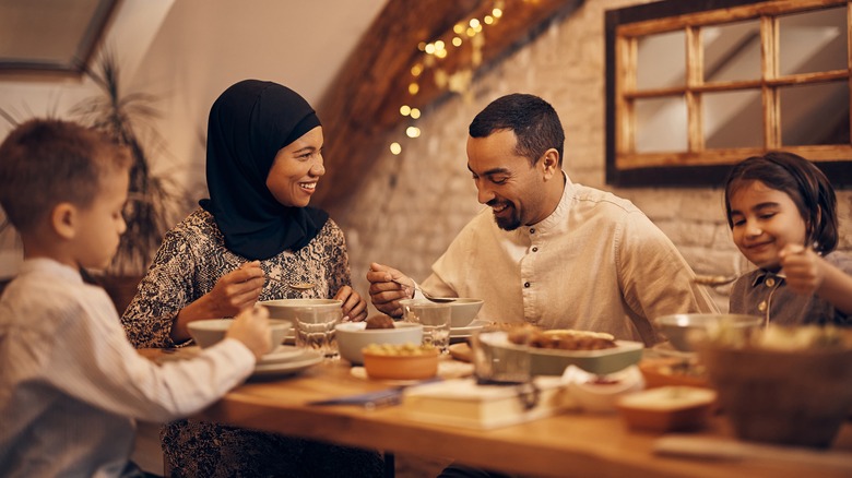 Muslim family eating around a table