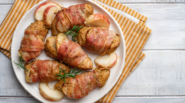 Chicken breasts wrapped in bacon on a plate