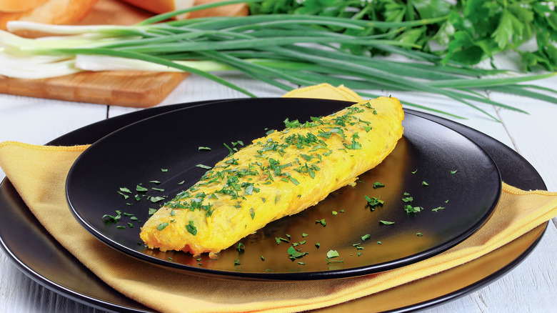 French omelet on a black plate