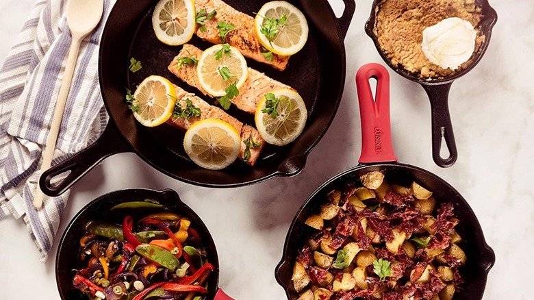 A Cuisinel cast iron skillet set with food