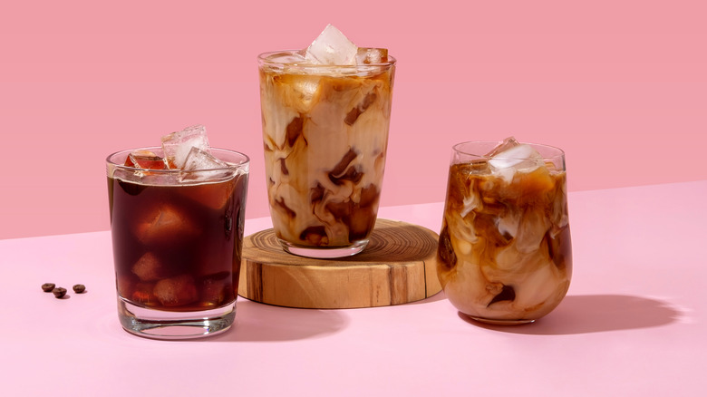 Three iced coffees pink background