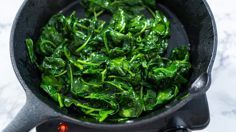  Sautéing spinach in a pan