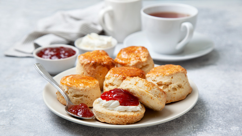 Scones and jam assorted on white plate