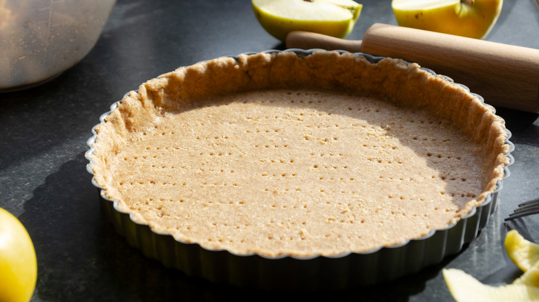 Pie crust beside apple slices