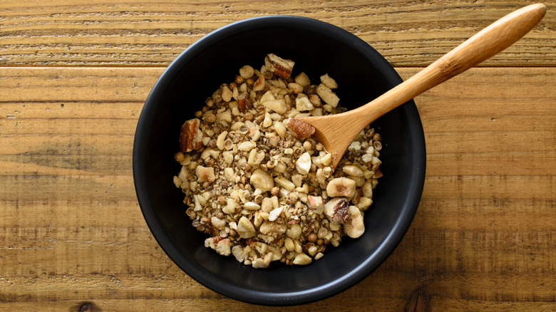 A bowl full of dukkah on a wooden background