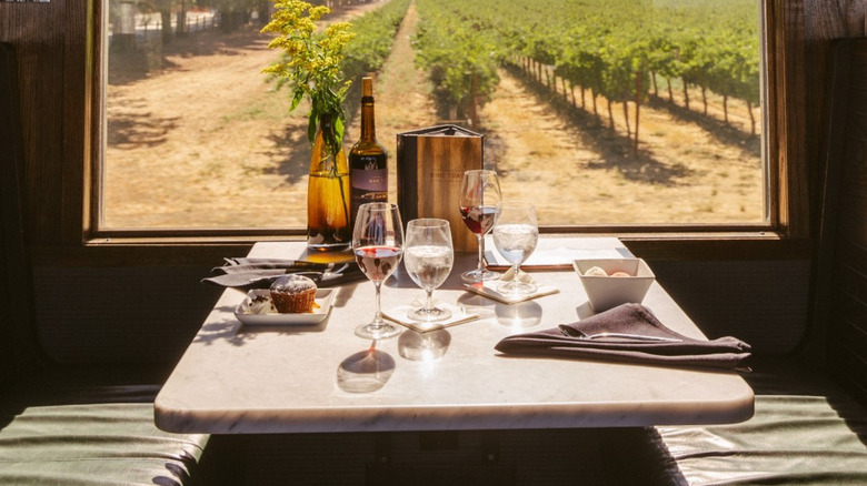 Table with wine glasses and dessert in train car