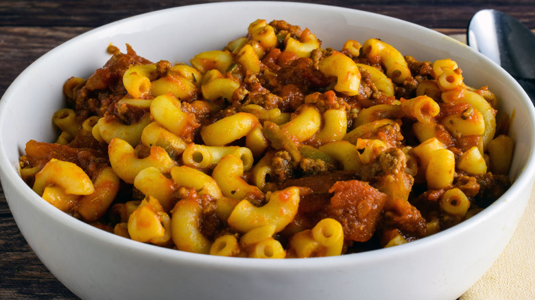 Bowl of American chop suey on wooden table
