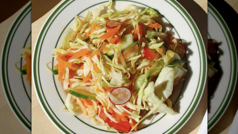 Bowl of shredded cabbage salad with assorted vegetables