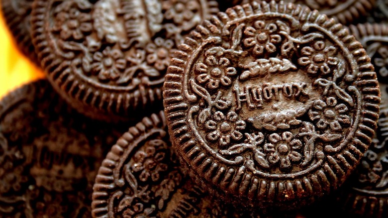 Hydrox cookies stacked on top of each other on yellow background