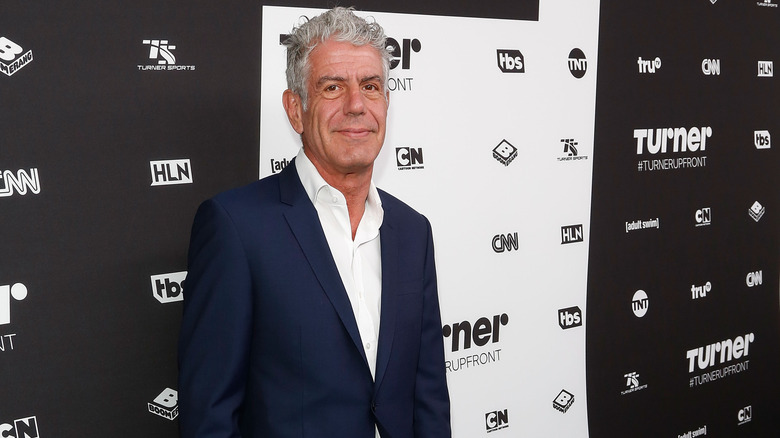 Anthony Bourdain posing on a red carpet