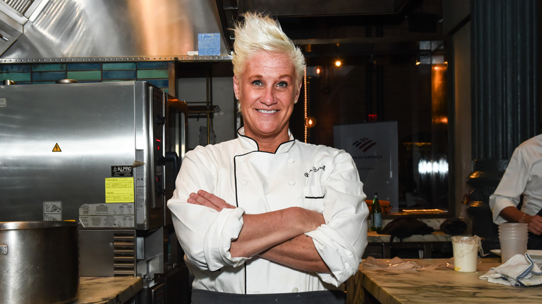 Chef Anne Burrell smiling with her arms crossed